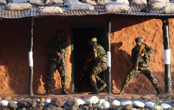Indian army soldiers display a cordon and search operation (CASO) during a training session at a corps battle school at Sarol in Rajouri, about 135 kilometers (84 miles) northwest of Jammu, India, Tue ...