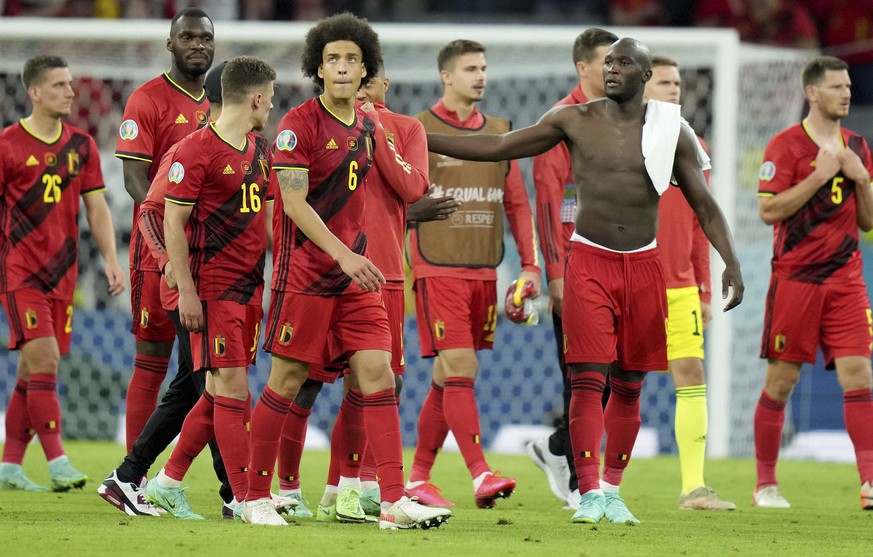 Belgian players leave the pitch after losing the Euro 2020 soccer championship quarterfinal match between Belgium and Italy at the Allianz Arena stadium in Munich, Germany, Friday, July 2, 2021. (AP P ...