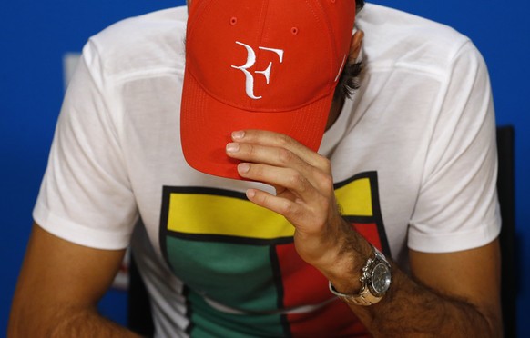 Roger Federer of Switzerland adjusts his cap at a press conference following his semifinal loss to to Novak Djokovic of Serbia at the Australian Open tennis championships in Melbourne, Australia, Thur ...
