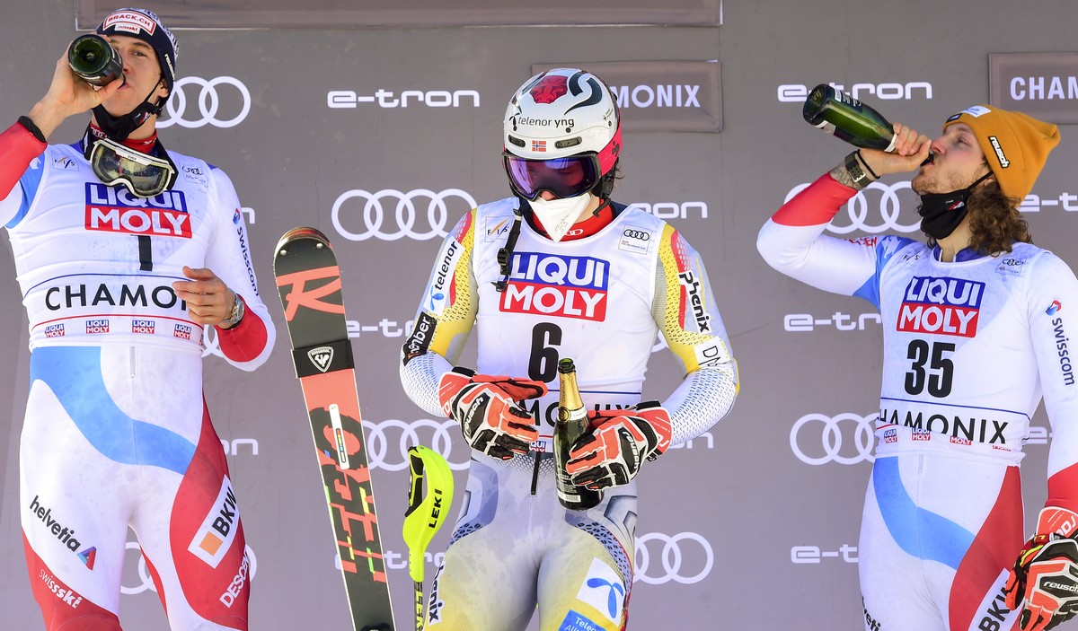 From left, second placed Switzerland's Ramon Zenhaeusern, winner Norway's Henrik Kristoffersen and third placed Switzerland's Sandro Simonet celebrate on podium of an alpine ski, men  ...