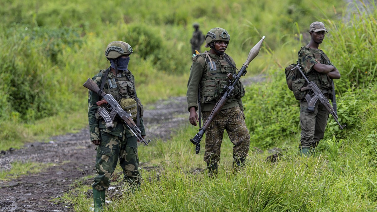 FILE - M23 rebels stand with their weapons in Kibumba, in the eastern of Democratic Republic of Congo, Dec. 23, 2022. (AP Photo/Moses Sawasawa, File)