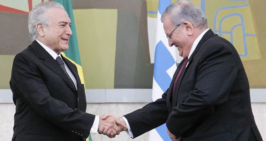 epa05691389 A handout photo made available by the Presidency of Brazil on 30 December 2016 shows Brazilian President Michel Temer (L) shaking hands with Greece&#039;s ambassador to Brazil Kyriakos Ami ...