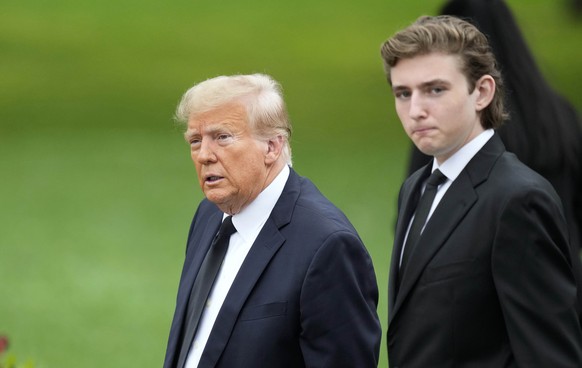 Former President Donald Trump, left, arrives with his son Barron for the funeral of the former first lady&#039;s mother at the Church of Bethesda-by-the-Sea in Palm Beach, Fla., Thursday, Jan. 18, 202 ...