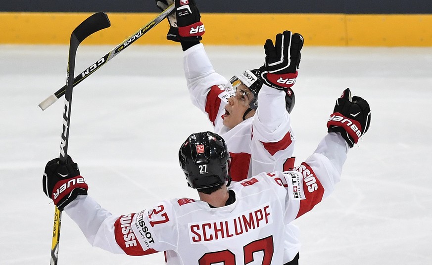 Switzerland’s Reto Suri, right, and Switzerland’s Dominik Schlumpf celebrate their second goal during their Ice Hockey World Championship group B preliminary round match between Switzerland and Czech  ...