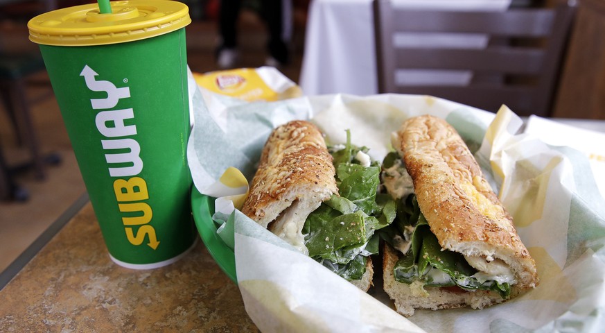 FILE - In this Friday, Feb. 23, 2018 file photo, the Subway logo is seen on a soft drink cup next to a sandwich at a restaurant in Londonderry, N.H.. Ireland