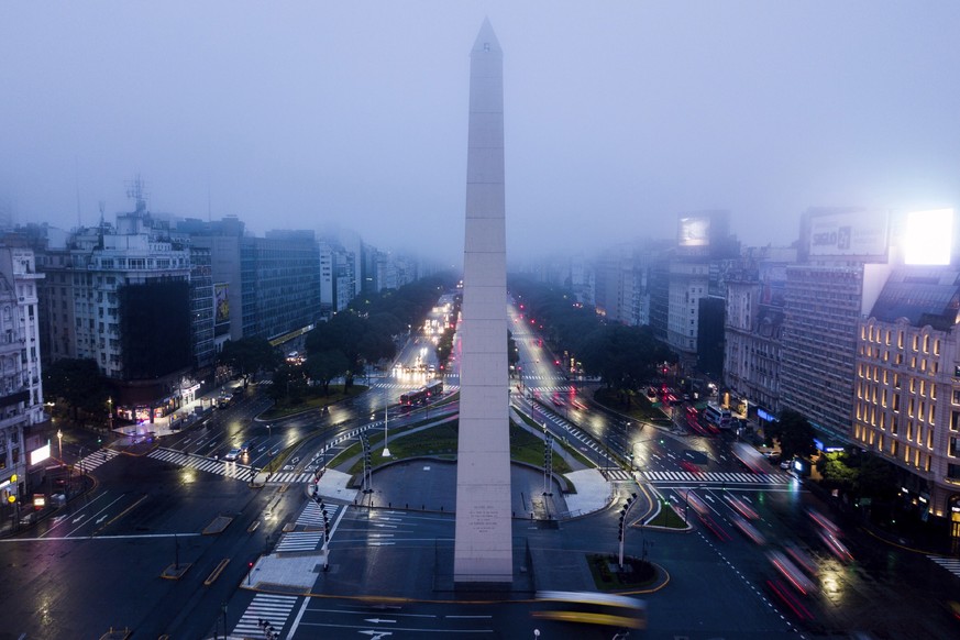 Cars drive on the 9 de Julio Ave, near the Obelisk monument in Buenos Aires, Argentina, early Monday morning, June 17, 2019. As lights turned back on across Argentina, Uruguay and Paraguay after a mas ...