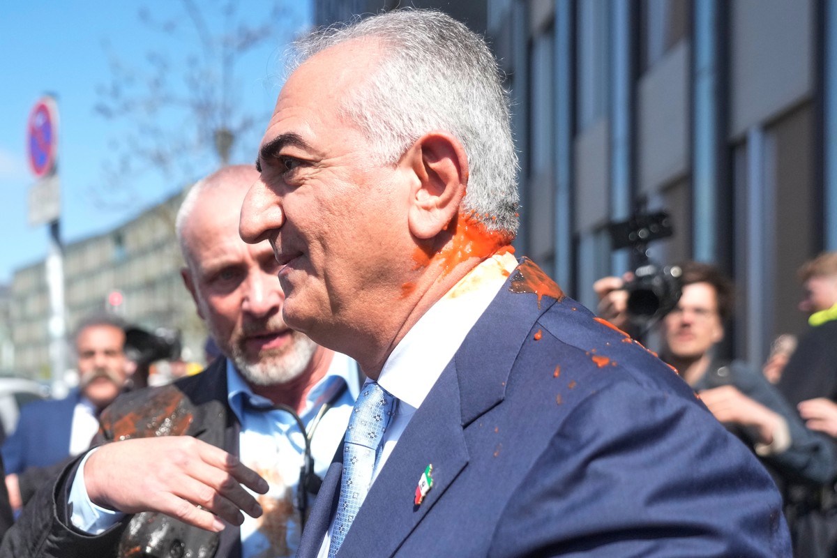 Iran's Reza Pahlavi, exiled son of Shah Reza Pahlavi, is protected by security after he was attacked with a red fluid, following a news conference in Berlin, Germany, Thursday, April 23, 2026. (A ...