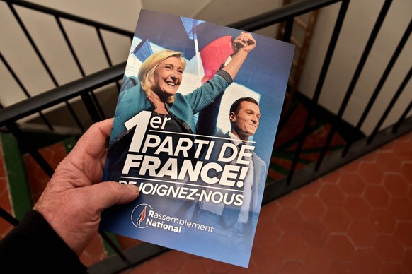 Leaflet of the Rassemblement National RN in Marseille, France - 11 Feb 2025 A man holds a Rassemblement National leaflet received in his mailbox a photo of Marine Le Pen L and Jordan Bardella R that s ...