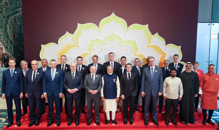 epa12756723 A handout photo made available by the Press Information Bureau (PIB) of global leaders posing with Indian Prime Minister Narendra Modi for a family photo at the AI Impact Summit 2026 at Bh ...