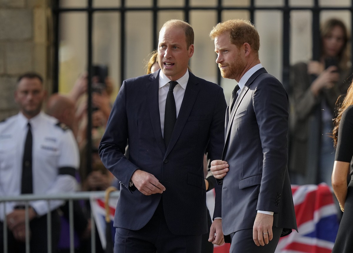 FILE - Britain's Prince William, left, and Britain's Prince Harry speak after viewing the floral tributes for the late Queen Elizabeth II outside Windsor Castle, in Windsor, England on Sept. ...
