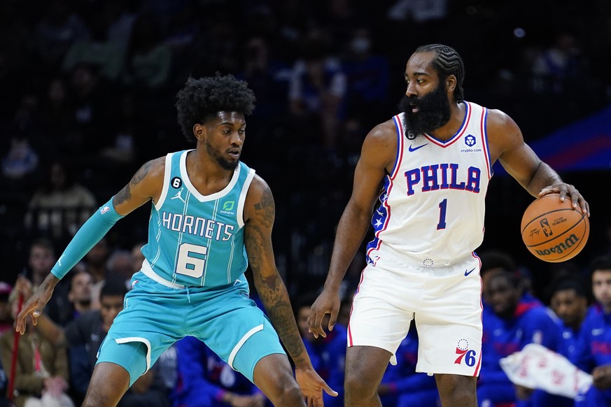 Philadelphia 76ers' James Harden, right, tries to get past Charlotte Hornets' Jalen McDaniels during the first half of a preseason NBA basketball game, Wednesday, Oct. 12, 2022, in Philadelphia. (AP P ...