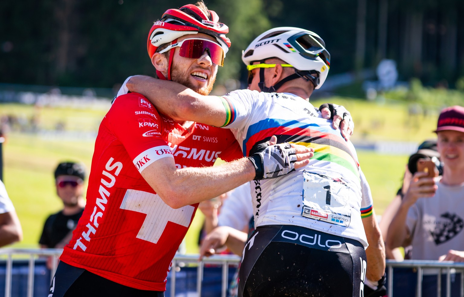 epa10009695 Mathias Flueckiger (L) of Switzerland celebrates with second placed compatriot Nino Schurter (R) after winning the UCI Cross Country Mountain Bike World Cup Men Elite race in Leogang, Aust ...