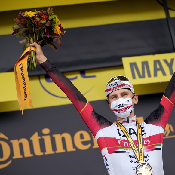 Slovenia's Tadej Pogacar celebrates on the podium after winning the fifth stage of the Tour de France cycling race, an individual time-trial over 27.2 kilometers (16.9 miles) with start in Change ...