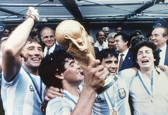 Diego Maradona of Argentina celebrates with the cup and his team mates at the end of the World Cup soccer final in the Atzeca Stadium, in Mexico City, Mexico, on June 29, 1986. Argentina defeated West ...