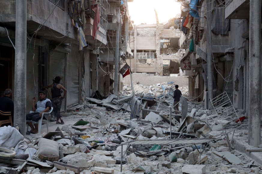 Residents inspect a damaged site after an airstrike in the besieged rebel-held al-Qaterji neighbourhood of Aleppo, Syria October 14, 2016. REUTERS/Abdalrhman Ismail