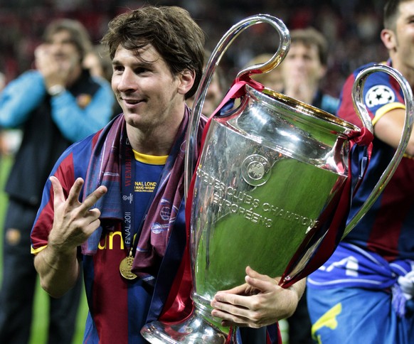 FILE - In this May 28, 2011 file photo Barcelona&#039;s Lionel Messi celebrates with the trophy after winning the Champions League final soccer match against Manchester United at Wembley Stadium, Lond ...