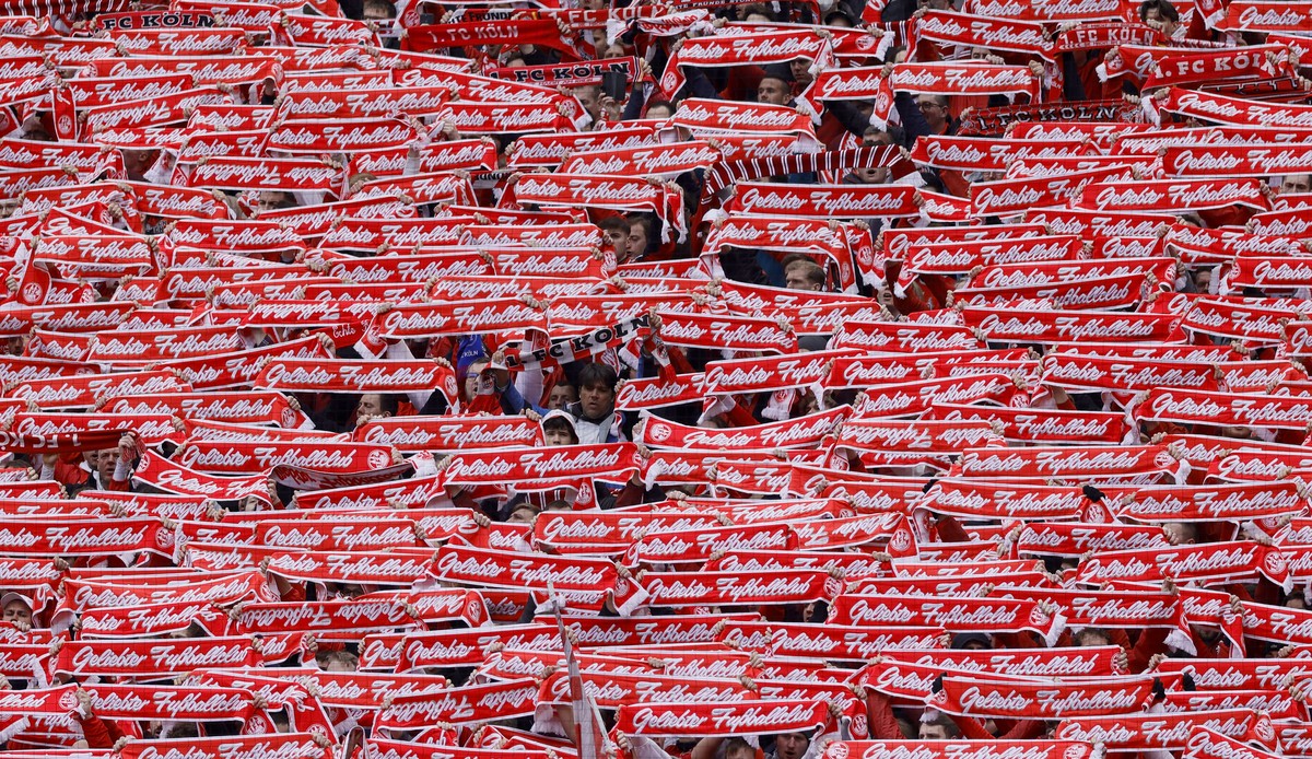 epa10555455 Fans of Cologne cheer during the German Bundesliga soccer match between 1. FC Cologne and Borussia Moenchengladbach in Cologne, Germany, 02 April 2023. EPA/RONALD WITTEK CONDITIONS - ATTEN ...