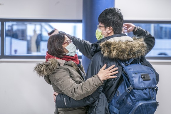 epa08185660 Tourists wearing face masks arrive to Lapland at Rovaniemi airport in Rovaniemi, Finland, 01 February 2020. The coronavirus, called 2019-nCoV, originating from Wuhan, China, has spread to  ...