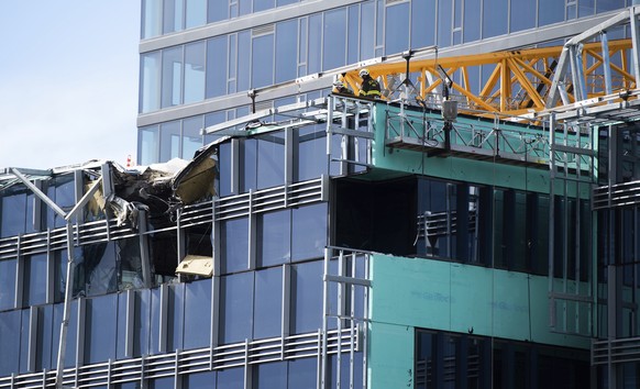 Emergency crews work the scene of a construction crane collapse near the intersection of Mercer Street and Fairview Avenue near Interstate 5 in Seattle, on Saturday, April 27, 2019. The crane was atop ...