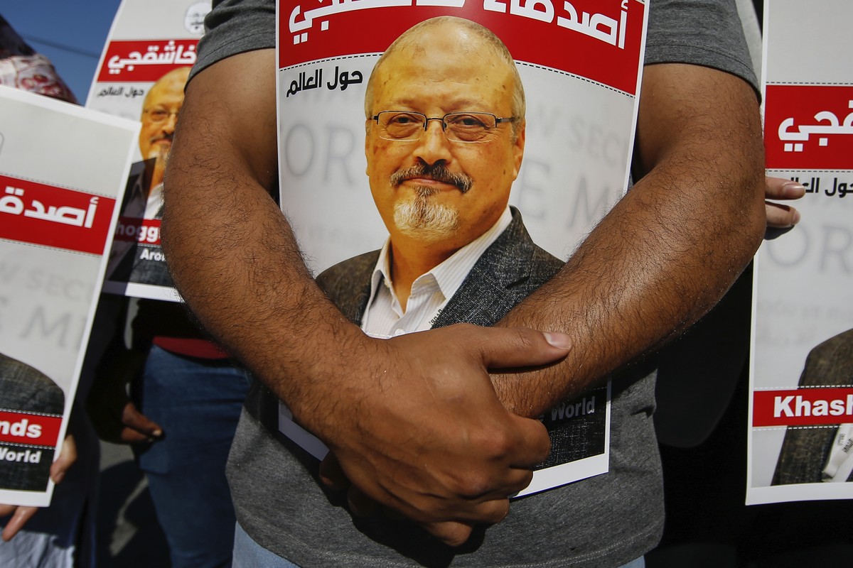 FILE - People hold posters of slain Saudi journalist Jamal Khashoggi, near the Saudi Arabia consulate in Istanbul, Oct. 2, 2020, marking the two-year anniversary of his death. In a surprise developmen ...