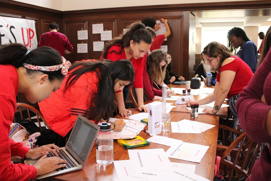 Nearly 200 undergraduates wearing red sat in the Winthrop House dining hall Friday to call for administrative action months after Winthrop Dean Ronald S. Sullivan, Jr. announced his decision to repres ...