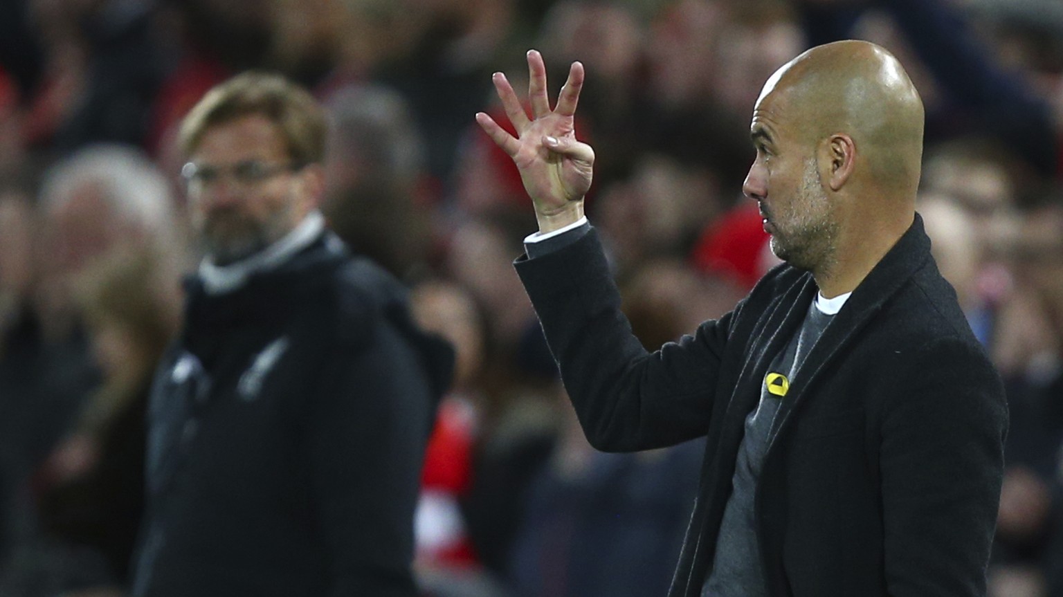 Manchester City coach Josep Guardiola, right, during the Champions League quarter final first leg soccer match between Liverpool and Manchester City at Anfield stadium in Liverpool, England, Wednesday ...