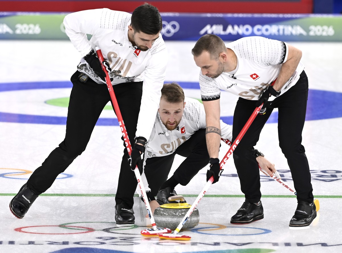 epa12751532 Switzerland's Yannick Schwaller (C) delivers the stone as teammates Pablo Lachat-Couchepin (L) and Sven Michel prepare to sweep in the Men's Curling match between Switzerland and ...