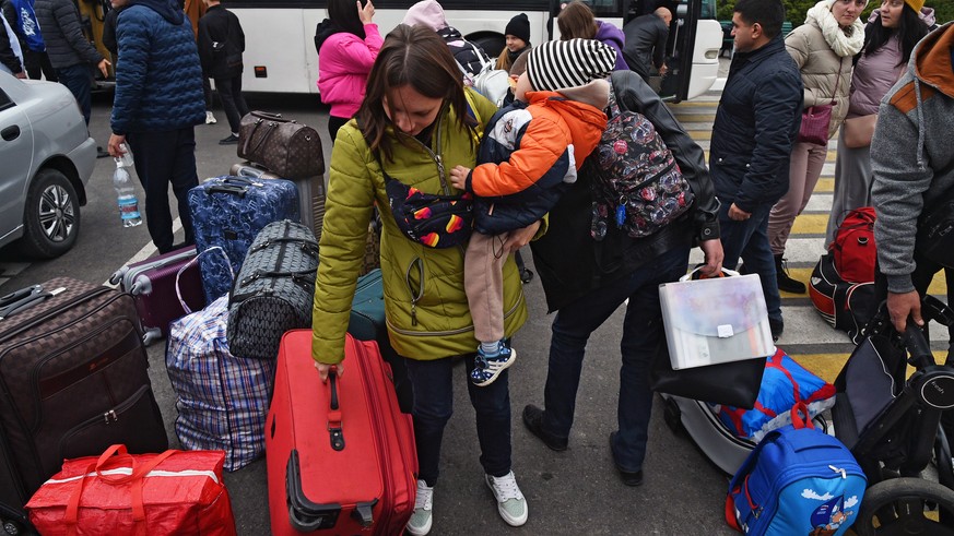 epa10257292 Local people evacuated from Kherson arrive to railway station in Dzhankoy, Crimea, 21 October 2022, where temporary accomodation centers have been set up. Kherson Region acting Governor Sa ...