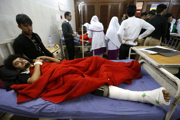 epa06360814 A man who was injured when terrorists attacked Peshawar University receives medical treatment at a hospital in Peshawar, Pakistan, 01 December 2017. At least nine people were killed and do ...