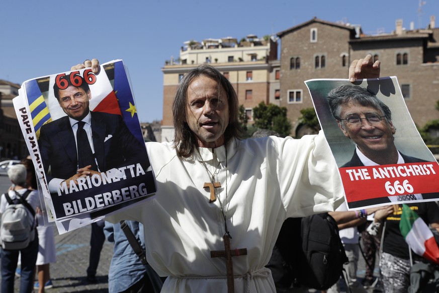 A no mask activists hold a portrait of Giuseppe Conte and one of Bill Gates during an anti-government and anti-COVID-19 restrictions protest in Rome, Saturday, Sept. 5, 2020. Italian Premier Giuseppe  ...