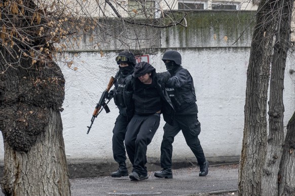 Armed riot police officers detain a protester during a security anti-terrorists operation in a street after clashes in Almaty, Kazakhstan, Saturday, Jan. 8, 2022. Kazakhstan&#039;s president authorize ...