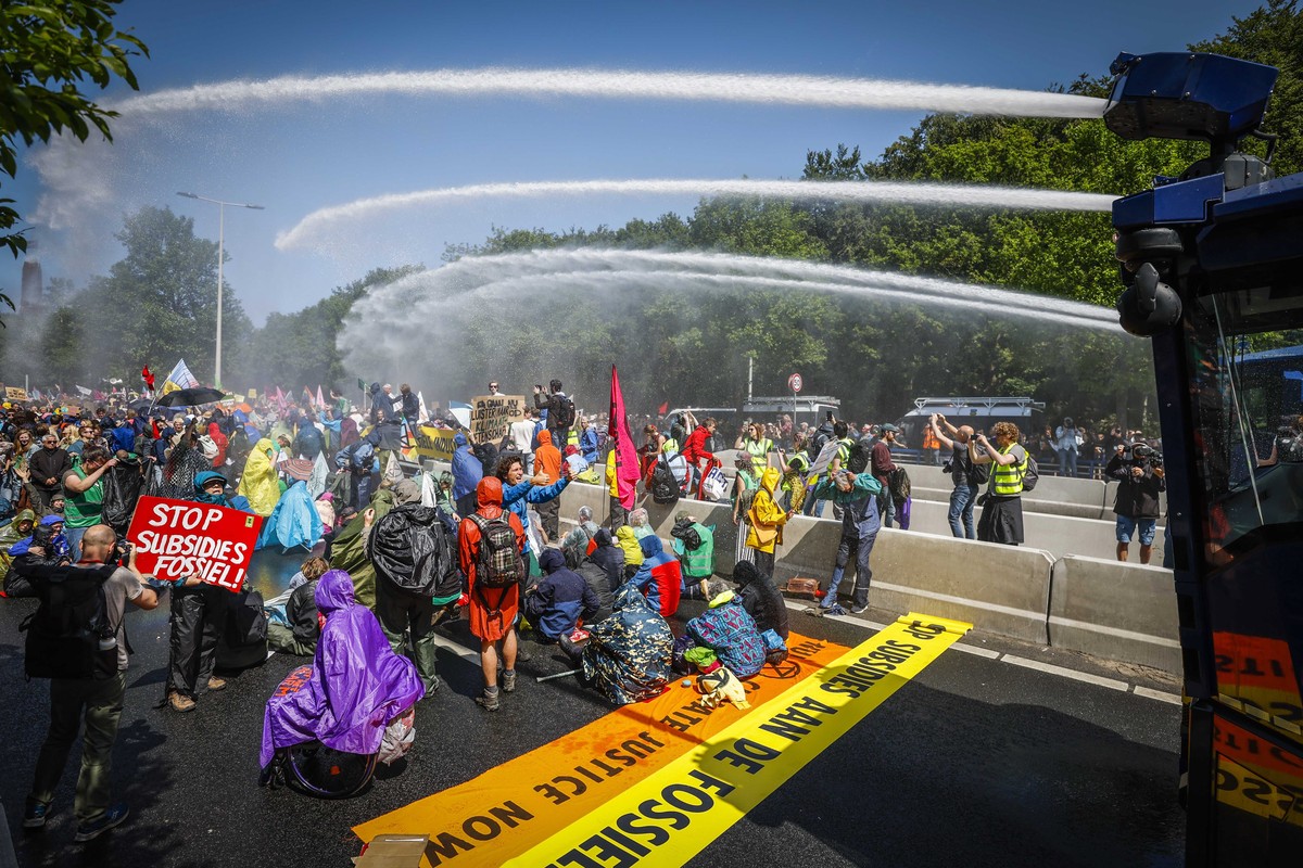 epa10657050 The police use water cannons against Extinction Rebellion activists who are blocking the A12, in The Hague, the Netherlands, 27 May 2023. With the action, Extinction Rebellion wants to mak ...