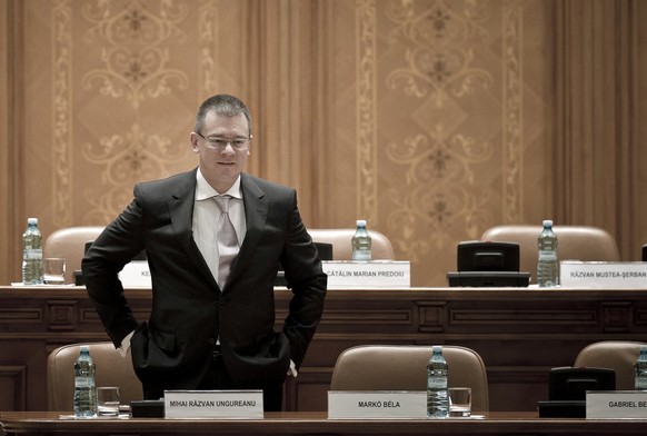 Romanian Prime Minister Mihai Razvan Ungureanu waits for the beginning of a special parliament session in Bucharest, Romania, Friday, April 27, 2012. Governments in Romania and the Czech Republic on F ...