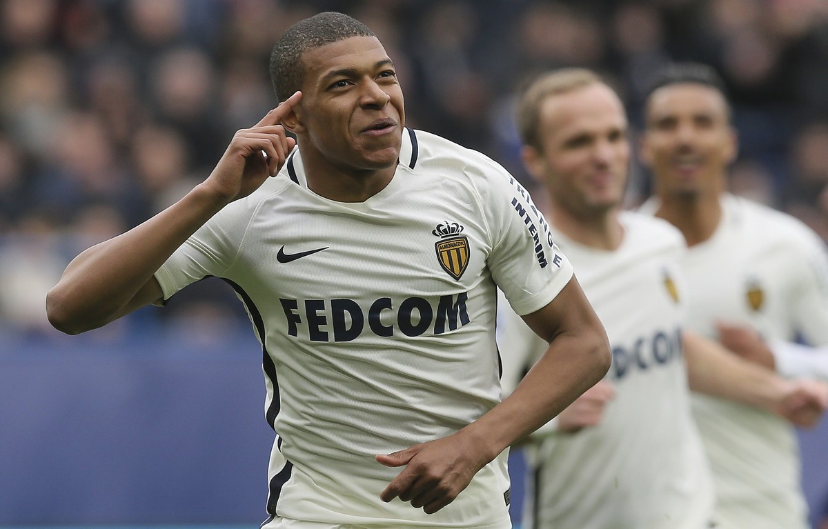 FILE - In this March 19, 2017, file photo, Monaco's Kylian Mbappe celebrates with teammates after he scored the first goal during their French League One soccer match against Caen, in Caen, north ...
