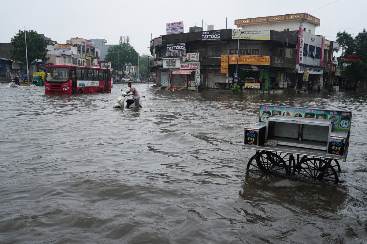 A man pushes his stalled two wheeler through a water-logged road during monsoon rain in Ahmedabad, India, Friday, July 24, 2026. (AP Photo/Ajit Solanki)
India Extreme Weather Monsoon