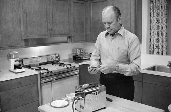 President Gerald Ford prepares English muffins, which he toasted in the kitchen of the family quarters at the White House, Thursday, Sept. 5, 1974, Washington. (AP Photo/Harvey Georges)
US Presidents  ...