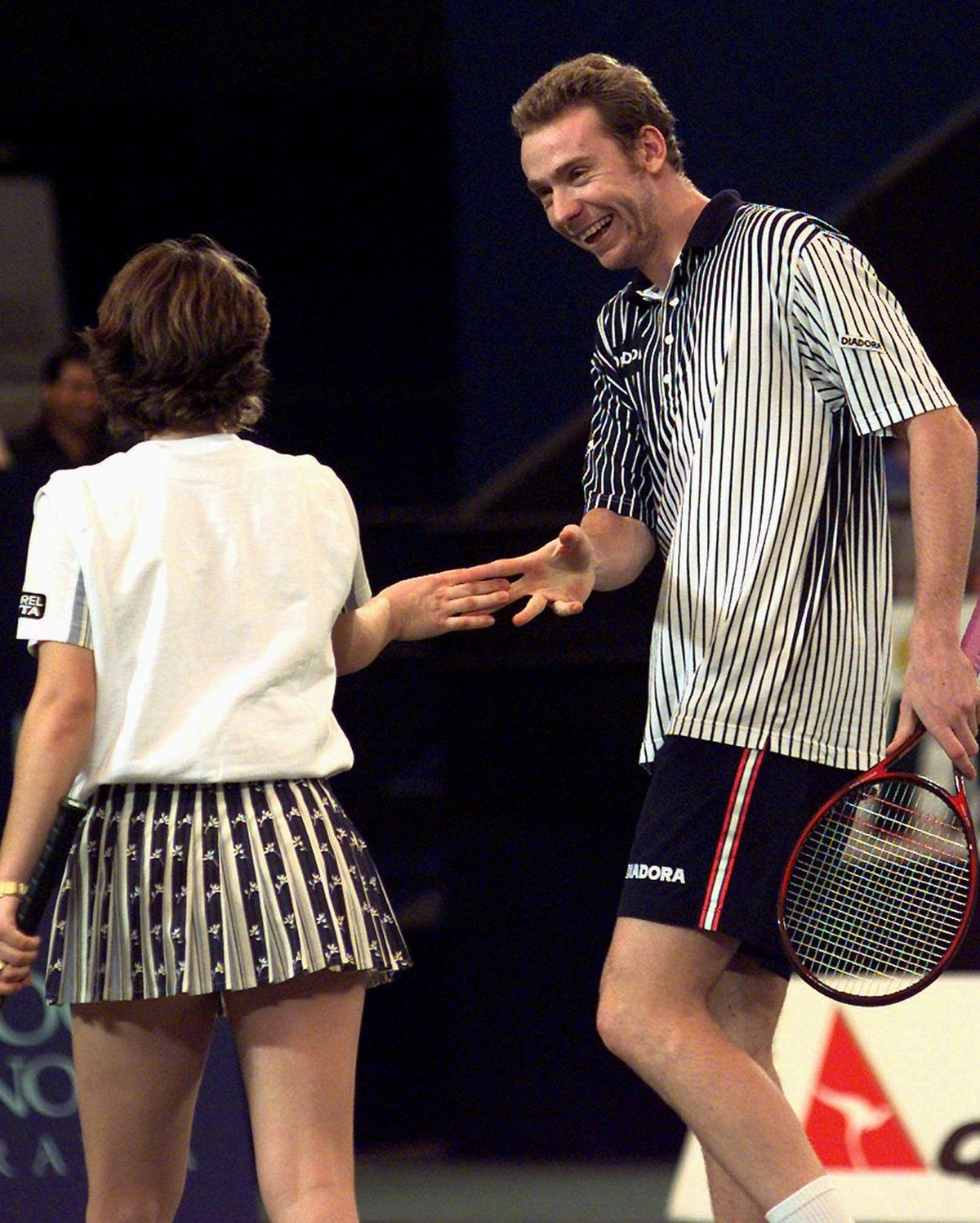 Marc Rosset and Martina Hingis of Switzerland and celebrate after winning a point during their match against Adrian Voinea and Irena Spirlea of Romania at the Hopman Cup international team competition ...