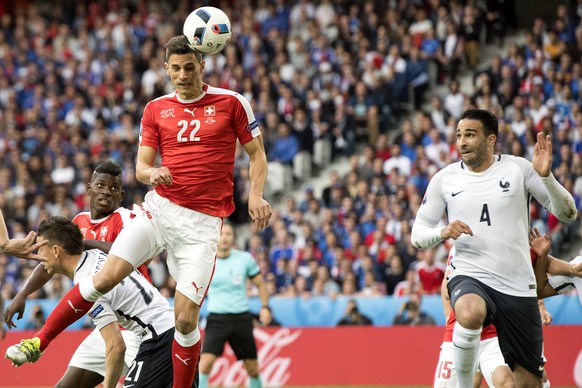 Swiss defender Fabian Schaer #22, shoots with his head past FranceÃs defender Laurent Koscielny, left back, Swiss forward Breel Embolo, 2nd left back, and FranceÃs defender Adil Rami, right, during  ...