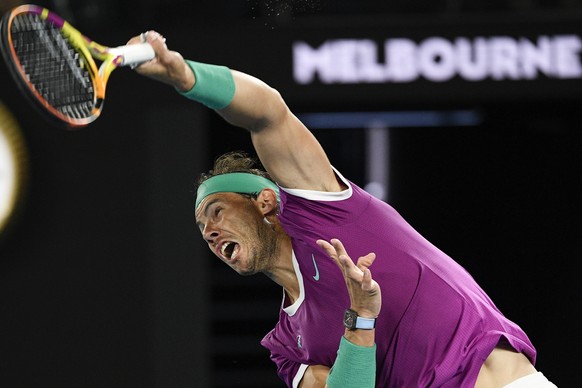 Rafael Nadal of Spain serves to Karen Khachanov of Russia during their third round match at the Australian Open tennis championships in Melbourne, Australia, Friday, Jan. 21, 2022. (AP Photo/Andy Brow ...