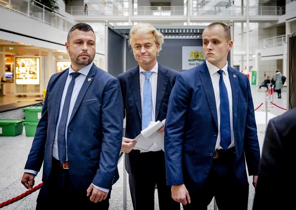 epa10988946 Party for Freedom (PVV) leader Geert Wilders (C) prepares to cast his vote in the House of Representatives elections at a polling station in The Hague, The Netherlands, 22 November 2023. D ...