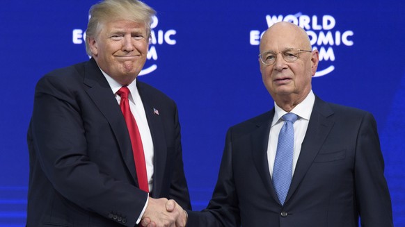 Donald Trump, President of the United States of America, left, shakes hands with German Klaus Schwab, Founder and Executive Chairman of the World Economic Forum, WEF the last day of the 48th Annual Me ...