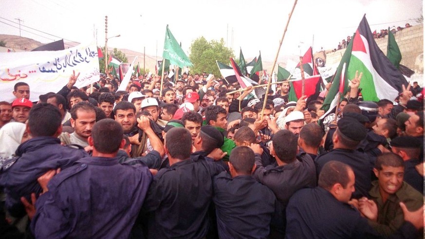380776 01: Jordanian policemen push back anti-Israeli protesters October 24, 2000 who march in support of Palestinians toward a Jordan River bridge leading to the West Bank. More than 10,000 demonstra ...
