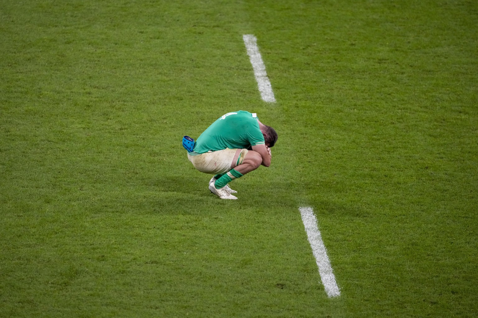 Ireland&#039;s Tadhg Beirne sits on the field at the end of the Rugby World Cup quarterfinal match between Ireland and New Zealand at the Stade de France in Saint-Denis, near Paris, Saturday, Oct. 14, ...