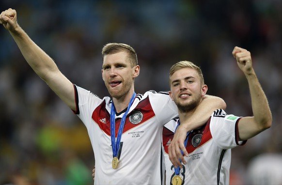 Germany&#039;s Per Mertesacker, left, and teammate Christoph Kramer celebrate after the World Cup final soccer match between Germany and Argentina at the Maracana Stadium in Rio de Janeiro, Brazil, Su ...