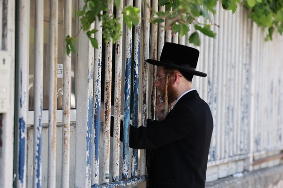 epa11436076 A utra-Orthodox Jewish man at the Israeli army recruitment office, in Jerusalem, 25 June 2024. Israeli Supreme Court panel of judges unanimously ruled that the state should recruit ultra-O ...