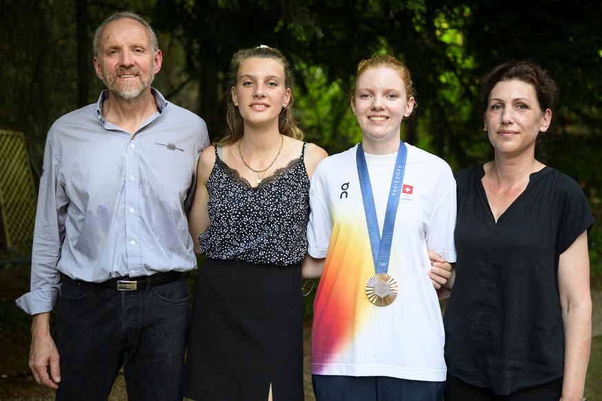 Audrey Gogniat, second from right, of Switzerland bronze medal winner in the women's 10m air rifle competition poses with, from left, her father Roland, sister Charlyne and mother Evelyne at the ...