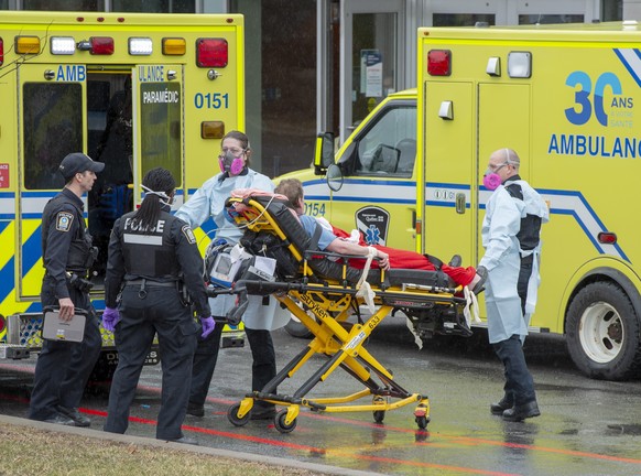 A patient is brought into the emergency unit of the Verdun Hospital, Thursday April 2, 2020 in Montreal. The hospital has seen a sharp spike in the number of COVID-19 cases among patients and staff. (Ryan Remiorz/The Canadian Press via AP)