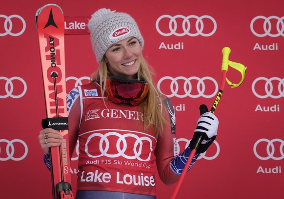 Mikaela Shiffrin, of the United States, celebrates her victory on the podium following the women&#039;s World Cup downhill skiing action in Lake Louise, Alberta, Saturday, Dec. 2, 2017. (Jeff McIntosh ...