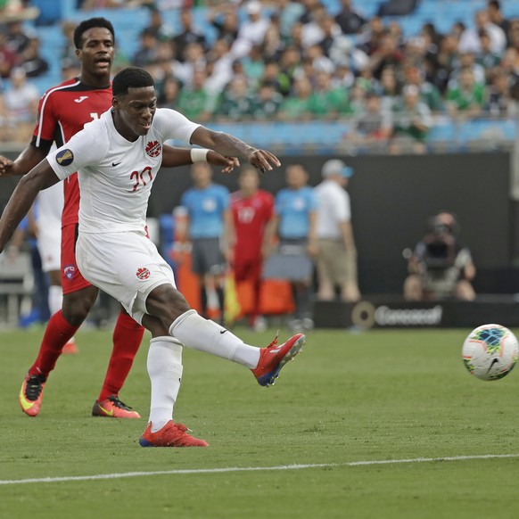 Canada&#039;s Jonathan David (20) kicks the ball past Cuba&#039;s Daniel Morejon (5) for a goal during the second half of a CONCACAF Golf Cup soccer match in Charlotte, N.C., Sunday, June 23, 2019. (A ...