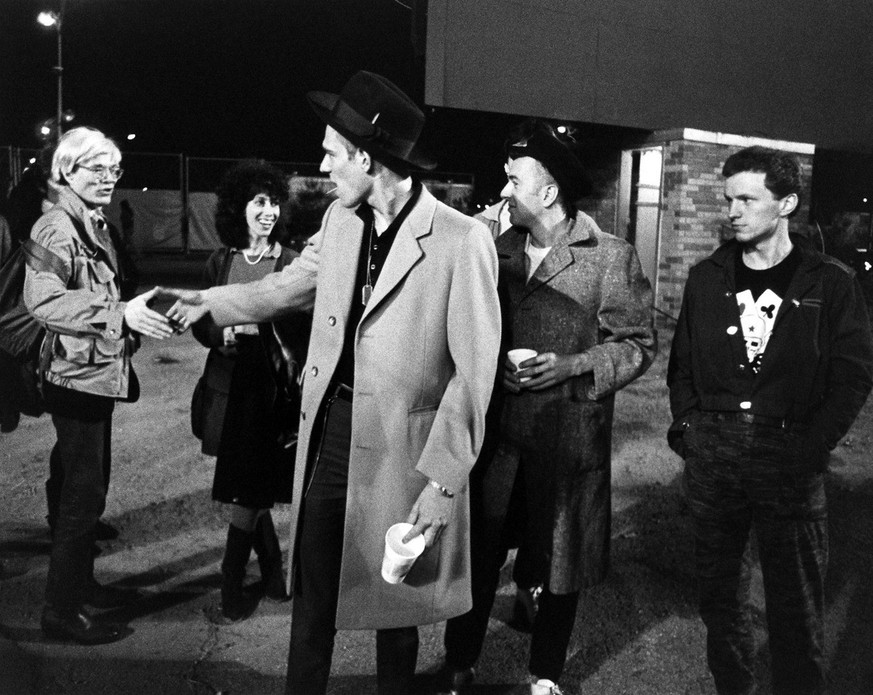 In this 1982 image released by Epic/Legacy Records, artist Andy Warhol, left, and publicist Susan Blond, second left, are shown backstage with members of The Clash, Paul Simonon, center, Joe Strummer  ...